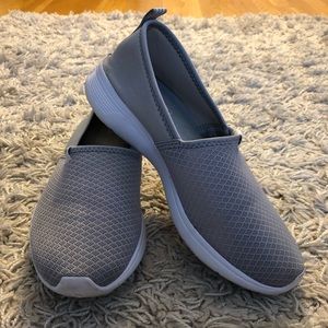 Grey adidas slip on shoes.